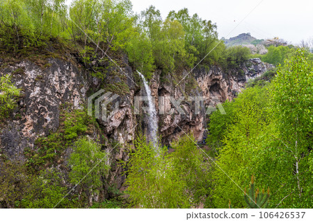 Honey waterfalls are under bright cloudy sky Honey waterfalls are under bright cloudy sky 106426537