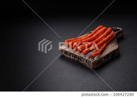 Delicious thin smoked hunting sausages with salt, spices and herbs 106427280