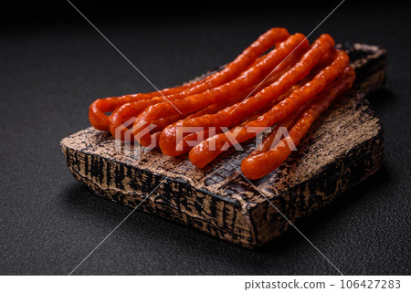 Delicious thin smoked hunting sausages with salt, spices and herbs Delicious thin smoked hunting sausages with salt, spices and herbs 106427283