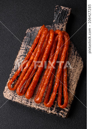 Delicious thin smoked hunting sausages with salt, spices and herbs 106427285
