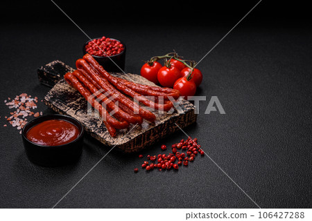 Delicious thin smoked hunting sausages with salt, spices and herbs Delicious thin smoked hunting sausages with salt, spices and herbs 106427288