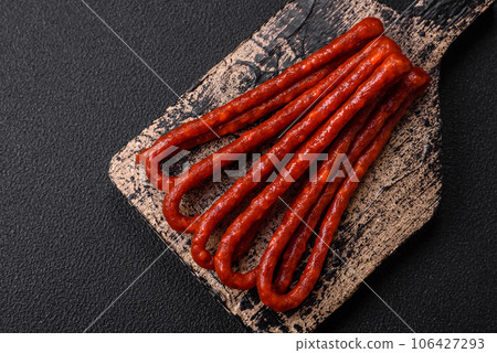 Delicious thin smoked hunting sausages with salt, spices and herbs Delicious thin smoked hunting sausages with salt, spices and herbs 106427293