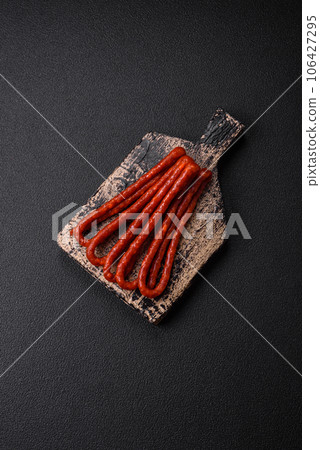 Delicious thin smoked hunting sausages with salt, spices and herbs 106427295