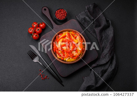 Delicious fresh saute sweet bell pepper slices with onion, salt, spices and herbs 106427337