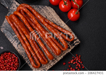 Delicious thin smoked hunting sausages with salt, spices and herbs Delicious thin smoked hunting sausages with salt, spices and herbs 106427431