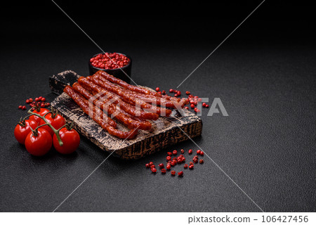 Delicious thin smoked hunting sausages with salt, spices and herbs Delicious thin smoked hunting sausages with salt, spices and herbs 106427456