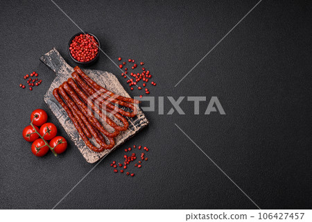 Delicious thin smoked hunting sausages with salt, spices and herbs 106427457