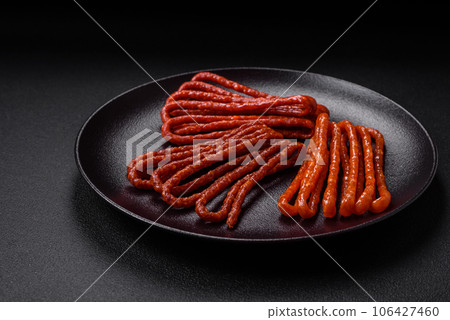 Delicious thin smoked hunting sausages with salt, spices and herbs Delicious thin smoked hunting sausages with salt, spices and herbs 106427460