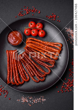 Delicious thin smoked hunting sausages with salt, spices and herbs Delicious thin smoked hunting sausages with salt, spices and herbs 106427466