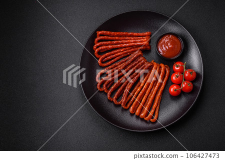 Delicious thin smoked hunting sausages with salt, spices and herbs Delicious thin smoked hunting sausages with salt, spices and herbs 106427473