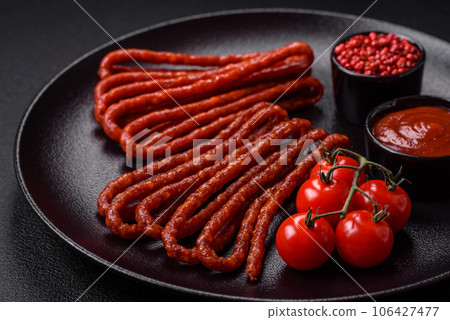 Delicious thin smoked hunting sausages with salt, spices and herbs Delicious thin smoked hunting sausages with salt, spices and herbs 106427477