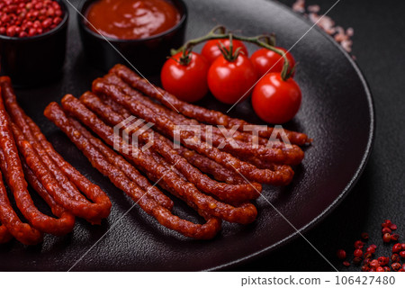 Delicious thin smoked hunting sausages with salt, spices and herbs Delicious thin smoked hunting sausages with salt, spices and herbs 106427480