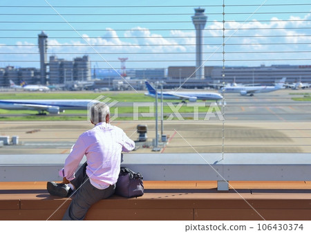 senior looking at airplane senior looking at airplane 106430374