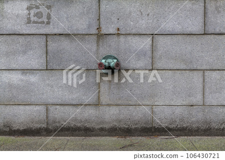 Fire hydrant water pipe, mounted in a building wall. Manhattan USA Fire hydrant water pipe, mounted in a building wall. Manhattan USA 106430721