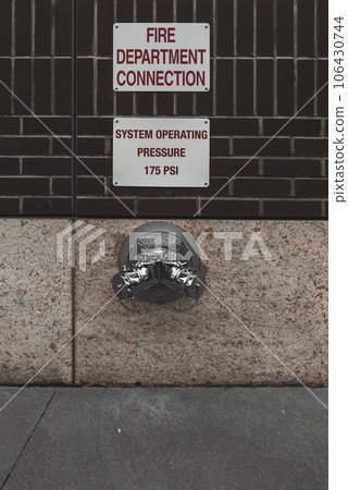 Fire hydrant water pipe, mounted in a building wall. Manhattan USA Fire hydrant water pipe, mounted in a building wall. Manhattan USA 106430744