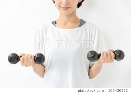 A woman with a dumbbell A woman with a dumbbell 106430822