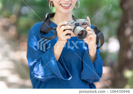 A woman with a camera A woman with a camera 106430946