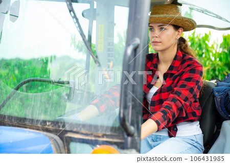 Girl farmer working on a tractor at a orchard 106431985