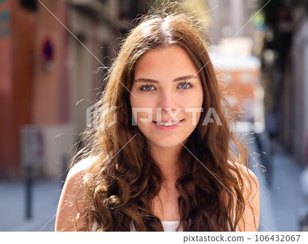 Cheerful attractive female walking on street outdoor 106432067