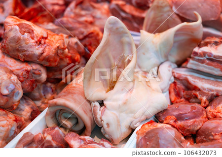 Fresh raw pork meat, bacon, ears and lard for sale in showcase 106432073