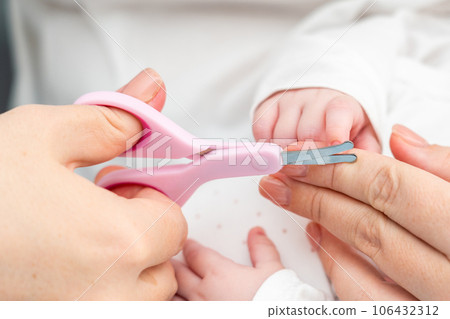 Newborn nails in focus. Concept of maternal attention to nail detail 106432312