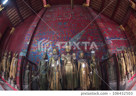 A group of ancient Buddha images of various sizes located within the Chariot Hall in Wat Xieng Thong is one of Laos most beautiful and richly decorated temple. 106432503