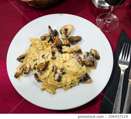 Fried scrambled egg with champignon mushroom, several slices of bran bread Fried scrambled egg with champignon mushroom, several slices of bran bread 106432524