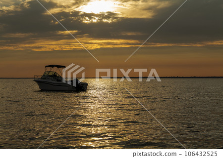 sun set and shadows of boats on a ocean in summer 106432525