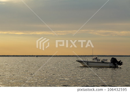 sun set and shadows of boats on a ocean in summer 106432595