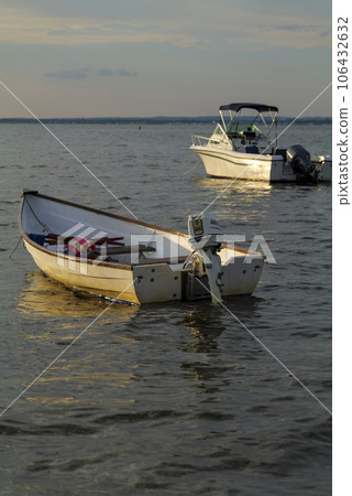 sun set and shadows of boats on a ocean in summer sun set and shadows of boats on a ocean in summer 106432632