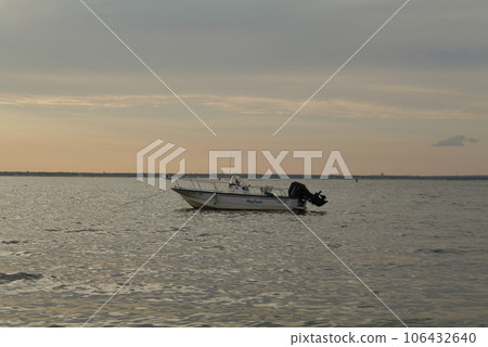 sun set and shadows of boats on a ocean in summer sun set and shadows of boats on a ocean in summer 106432640