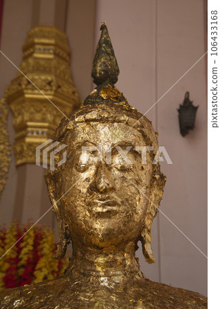 The face of the golden standing Buddha in close-up covered with a sheet of gold paper which shows the respect of the people at Phra Pathom Chedi in Nakhon Pathom Province , Middle of Thailand. The face of the golden standing Buddha in close-up covered with a sheet of gold paper which shows the respect of the people at Phra Pathom Chedi in Nakhon Pathom Province , Middle of Thailand. 106433168