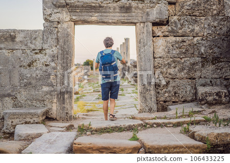 Tourist man at the ruins of ancient city of Perge near Antalya Turkey Tourist man at the ruins of ancient city of Perge near Antalya Turkey 106433225