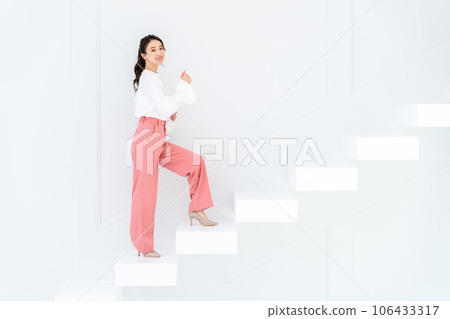 A young woman standing up the stairs A young woman standing up the stairs 106433317