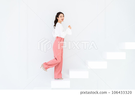 A young woman standing up the stairs A young woman standing up the stairs 106433320