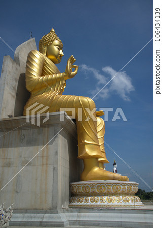 Outdoor large Buddha golden and white in the sitting position beautiful enshrined in front of the church of Wat Charoenratbamrung or Wat Nong Pong Nok temple. Located at Nakhon Pathom in Thailand. 106434139
