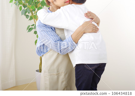woman hugging a boy 106434818