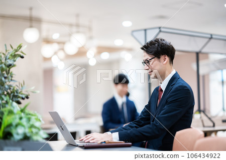 A businessman working in a coworking space A businessman working in a coworking space 106434922