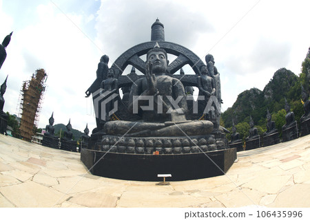 Lava Stone Buddha statue made of stone. and cast with high heat until it melts into lava and forming a large and very beautiful black Buddha image at Wat Thamkrabok. Located at Saraburi in Thailand. 106435996