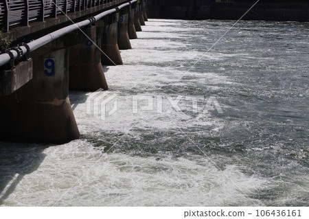 Scenery of the wash weir with all the flood gates open and water being released. 106436161