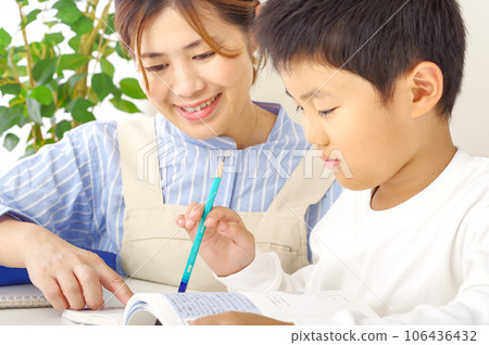 A boy who studies hard and a mother who teaches A boy who studies hard and a mother who teaches 106436432