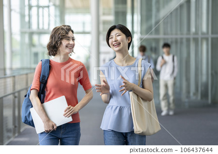 Two female students talking with a smile Study abroad and global education image Two female students talking with a smile Study abroad and global education image 106437644