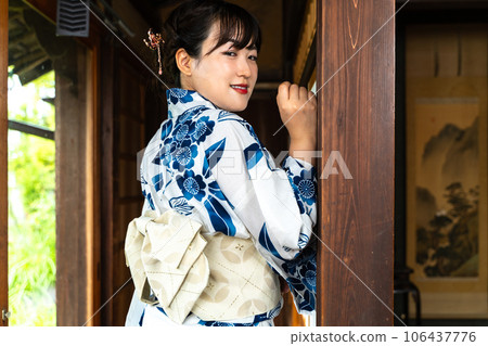 一個穿著浴衣的女人在門廊上擺姿勢 一個穿著浴衣的女人在門廊上擺姿勢 106437776
