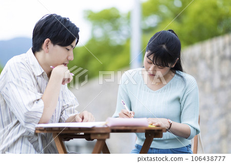 Men and women studying on the terrace Men and women studying on the terrace 106438777