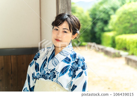 A woman in a yukata standing in a Japanese house A woman in a yukata standing in a Japanese house 106439015