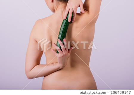 Woman female topless body standing isolated over white background with cucumber 106439147