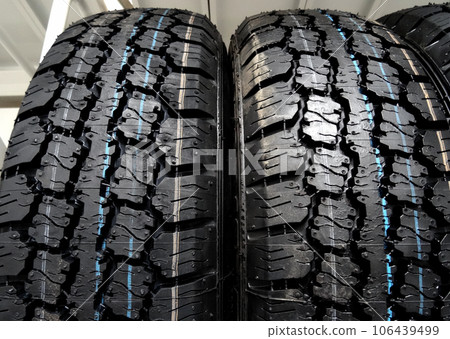 New winter tires with aggressive protector design on a shelf detailed 106439499