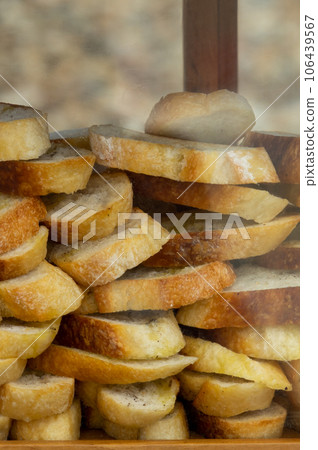 Cutting fresh baked loaf wheat baguette bread  106439567