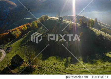 Aerial view of autumn countryside farm, with abandoned wooden houses and barns in the mountains 106440181