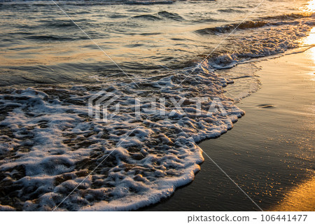 Waves approaching sandy beach 106441477